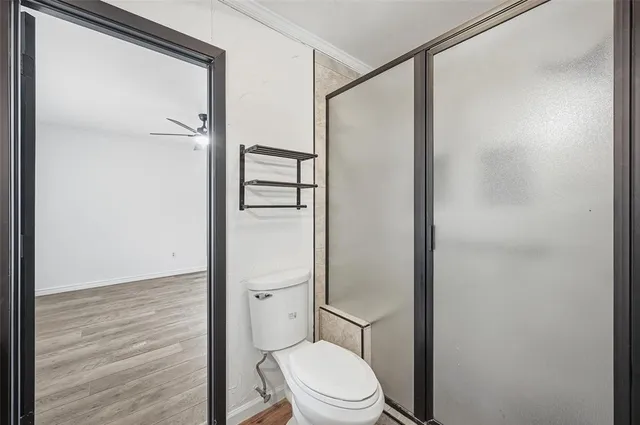 a white toilet sitting next to a bathroom sink