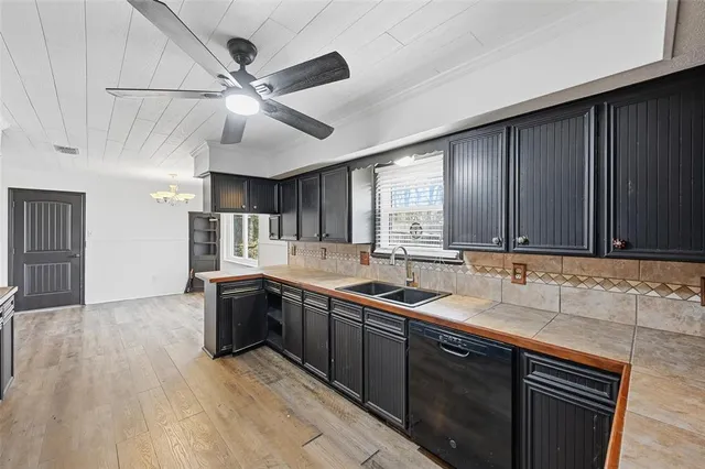 a kitchen with a sink cabinets and window