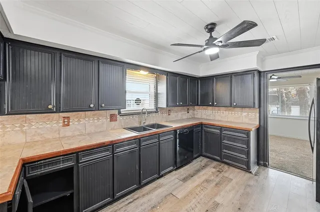 a kitchen with a sink and cabinets