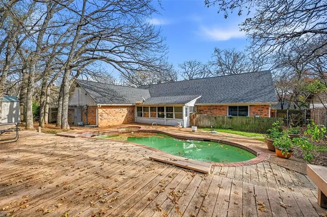 a front view of a house with swimming pool having outdoor seating