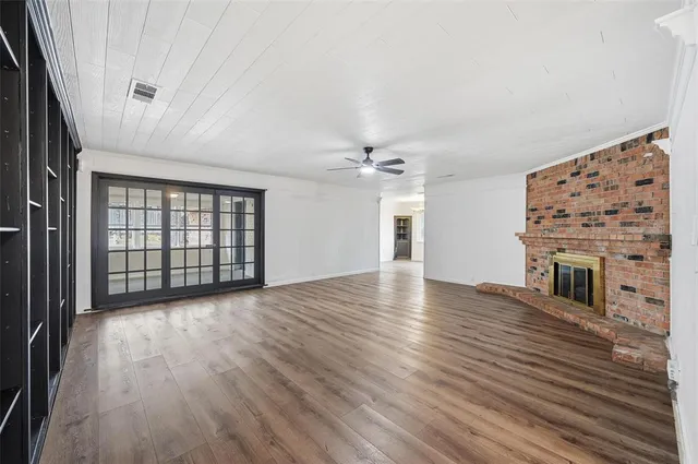 wooden floor in an empty room with a fireplace
