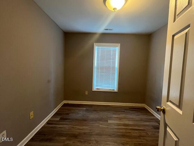 5419 Gunnette Drive Raleigh, NC 27610 - Photo 11 of 14 a view of an empty room with wooden floor and a window