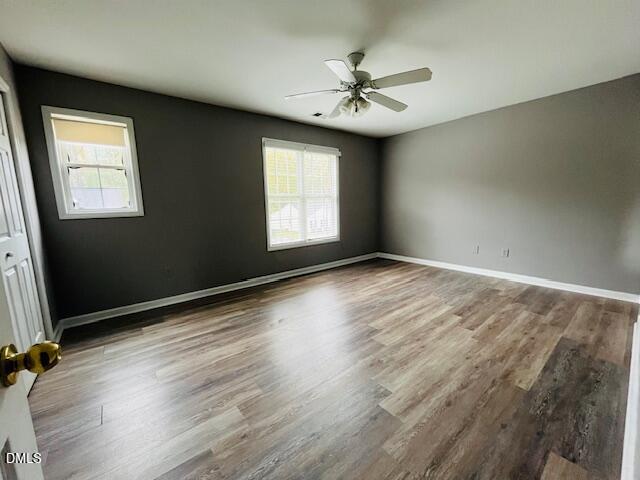 5419 Gunnette Drive Raleigh, NC 27610 - Photo 12 of 14 a view of an empty room with a window and wooden floor