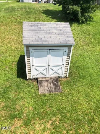 a view of a stone house with a yard