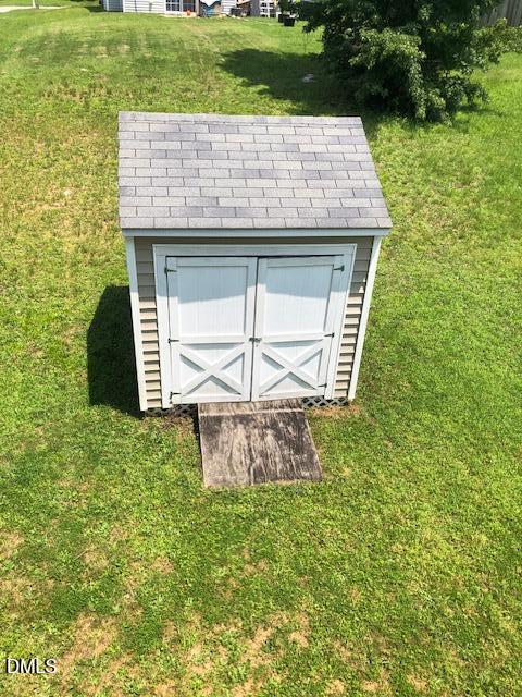 5419 Gunnette Drive Raleigh, NC 27610 - Photo 14 of 14 a view of a stone house with a yard