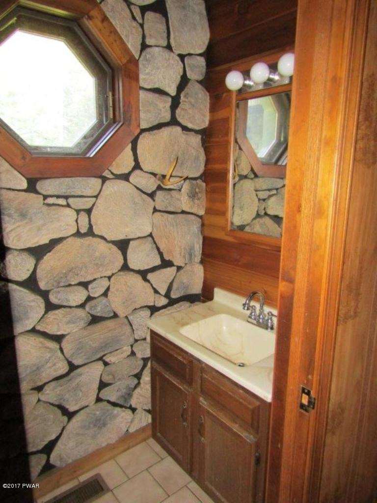 227 Hemlock Grove Road Newfoundland, PA 18445 - Photo 29 of 49 a bathroom with a sink and a mirror