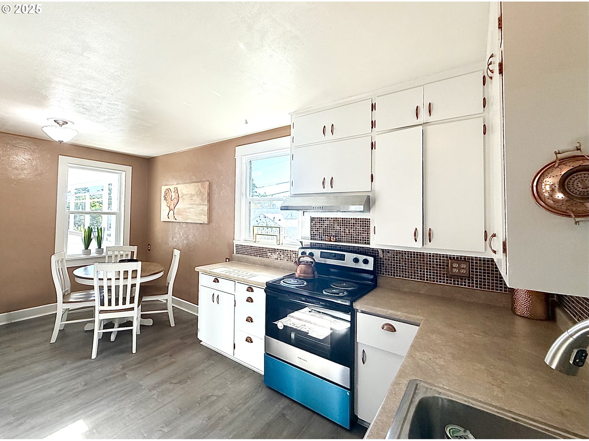 632 Southwest Utah Street Camas, WA 98607 - Photo 7 of 27 a kitchen with a stove a table and chairs
