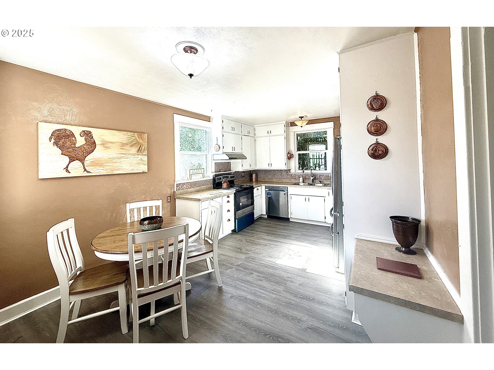 632 Southwest Utah Street Camas, WA 98607 - Photo 8 of 27 a dining room with wooden floor and large windows