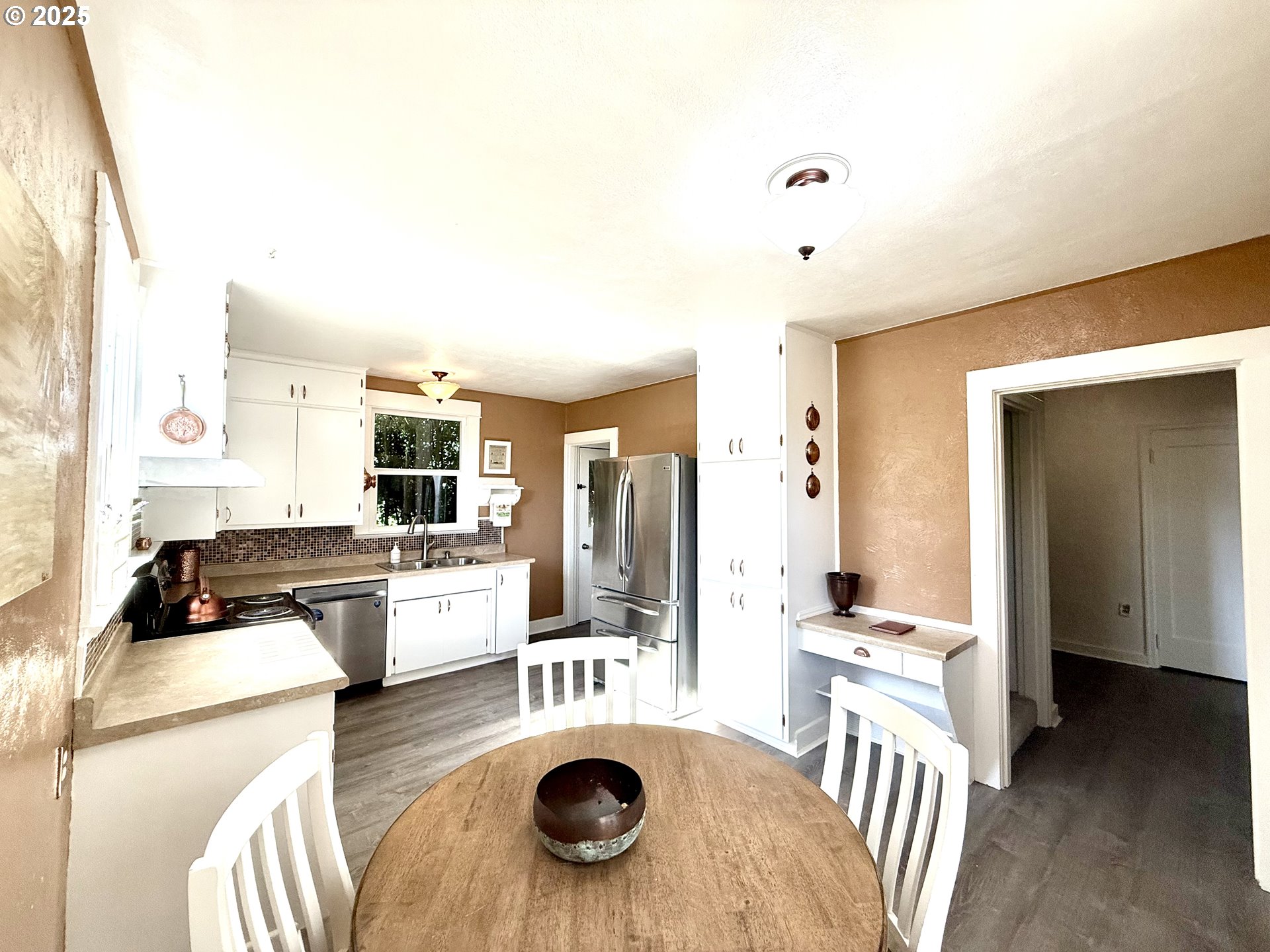 632 Southwest Utah Street Camas, WA 98607 - Photo 9 of 27 a large kitchen with a table chairs refrigerator and stove