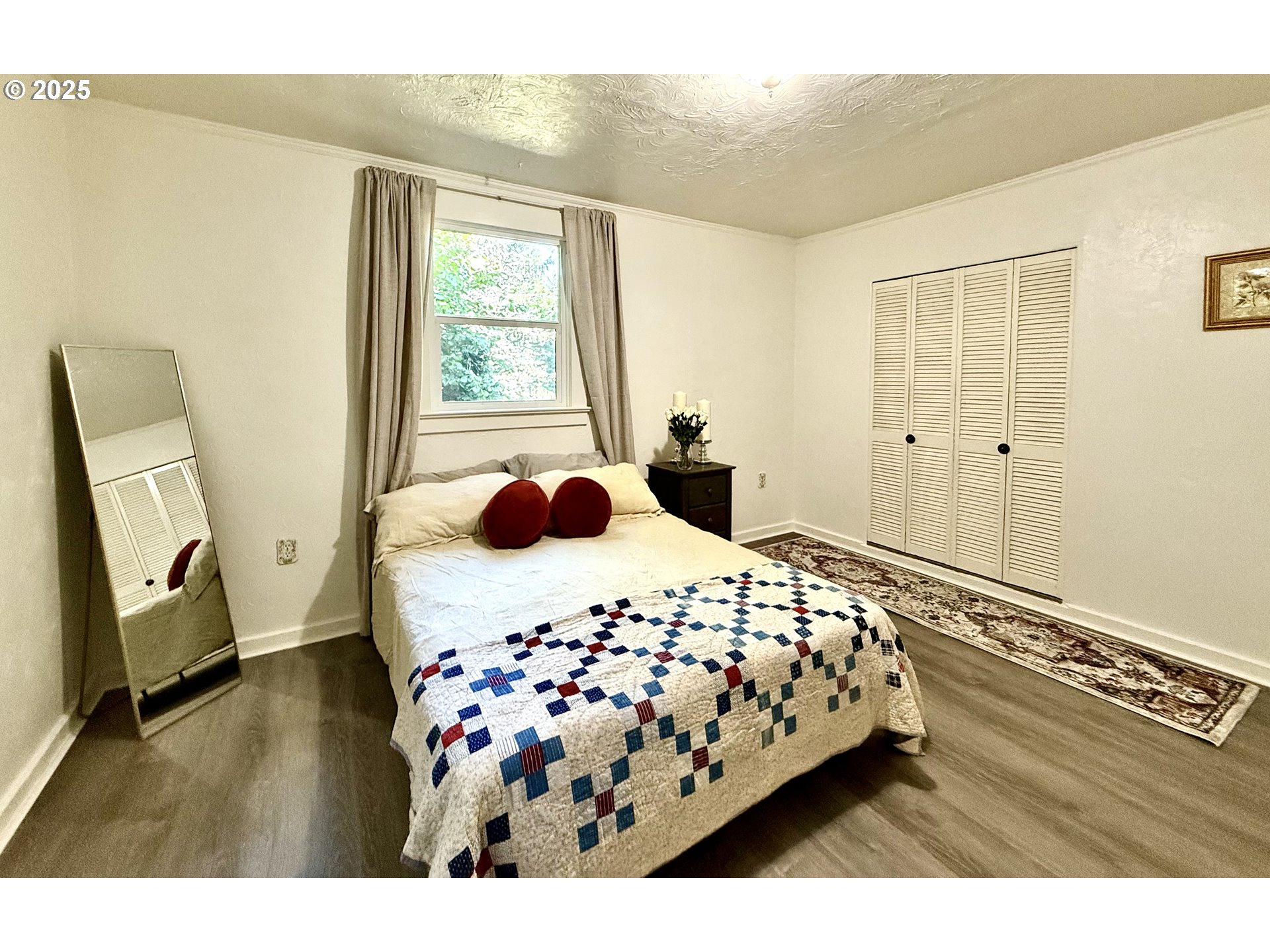 632 Southwest Utah Street Camas, WA 98607 - Photo 10 of 27 a bedroom with a bed and wooden floor