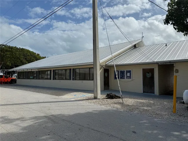 a front view of a building with small garden