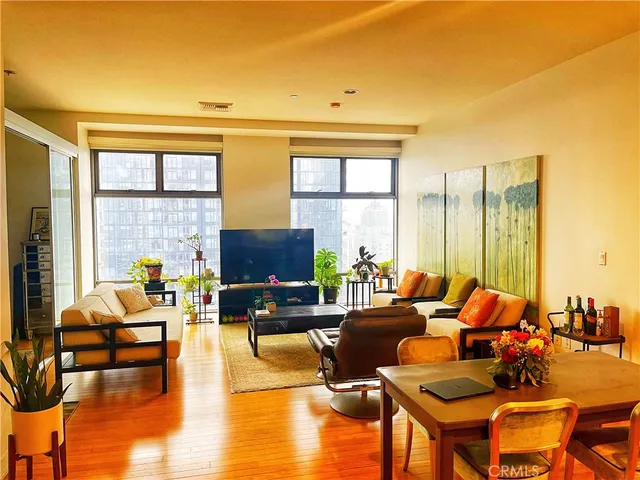 a living room with fireplace furniture and a large window