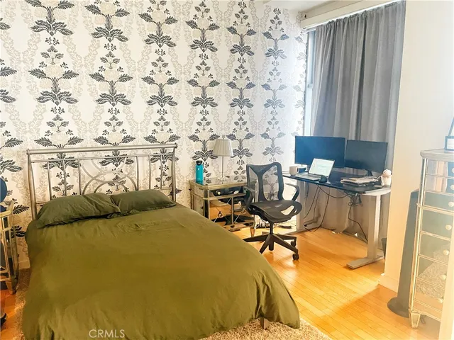 a bed sitting in a room next to a window