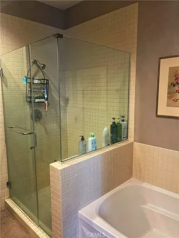 a bathroom with a tub and shower