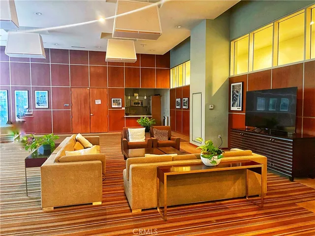 a dining room filled with furniture and a flat screen tv