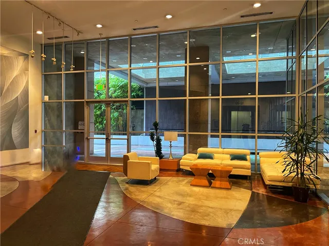 a living room filled with furniture and a large window