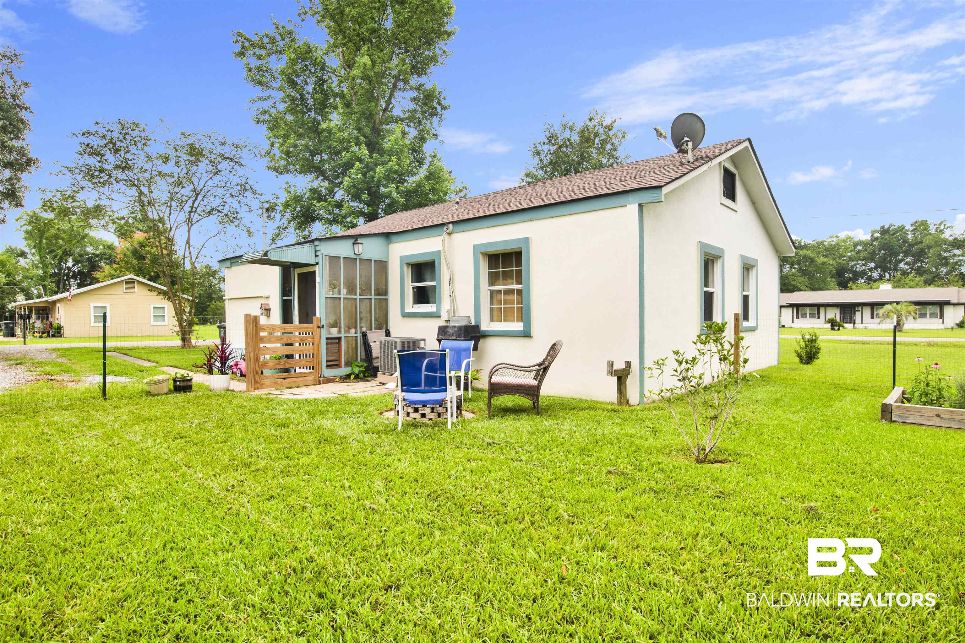 1100 North Pine Street Foley, AL 36535 - Photo 24 of 30 White exterior with blue trim accents and a gabled roofline