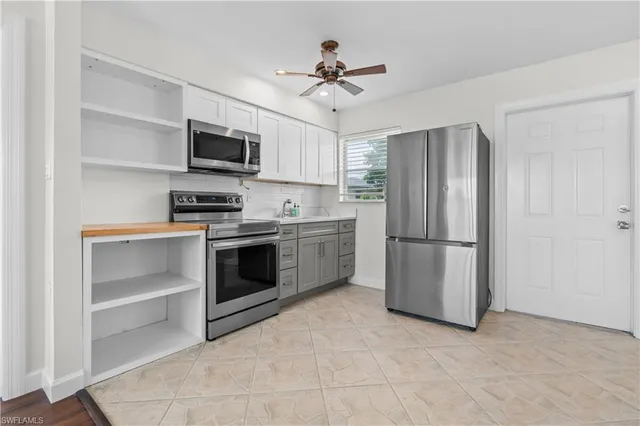 a kitchen with stainless steel appliances a refrigerator stove and microwave