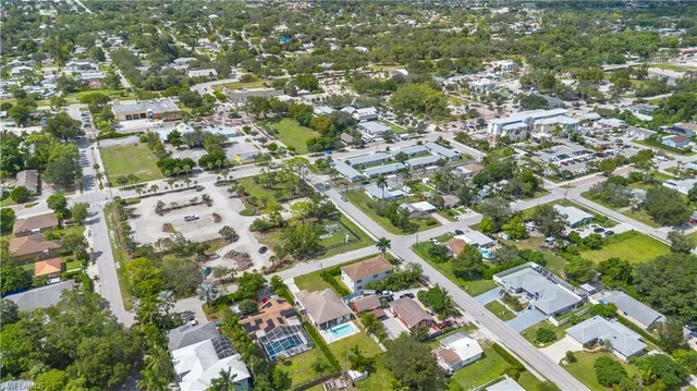 an aerial view of residential houses with open green space