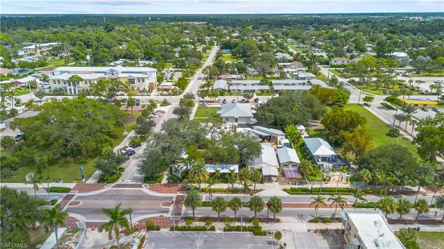 an aerial view of residential houses with outdoor space and street view