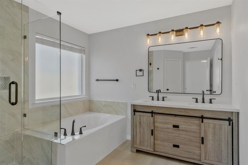 4172 Freedom Lane Frisco, TX 75033 - Photo 19 of 28 a bathroom with a tub sink and mirror