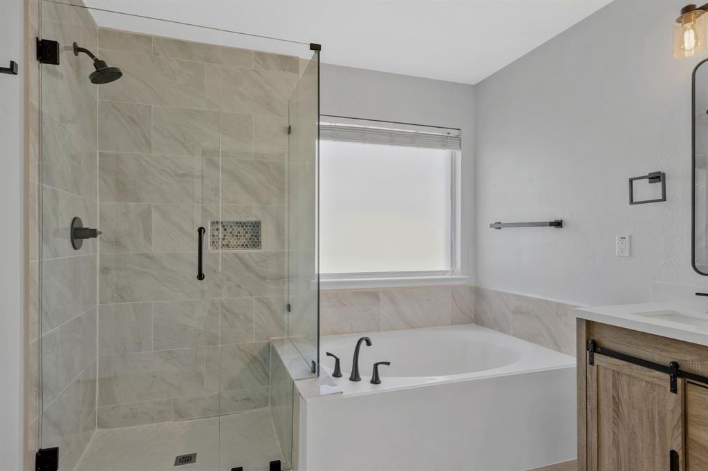 4172 Freedom Lane Frisco, TX 75033 - Photo 20 of 28 a white bath tub sitting next to a white sink and vanity