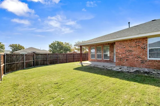 a swimming pool with outdoor seating and yard