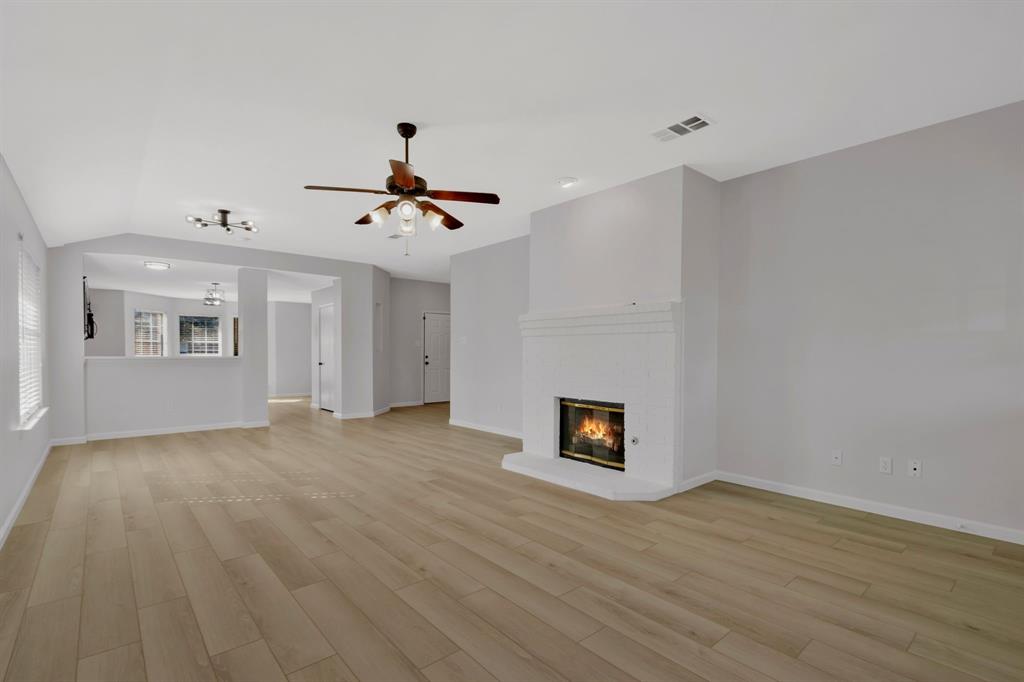 4172 Freedom Lane Frisco, TX 75033 - Photo 7 of 28 a view of an empty room with a fireplace and a window
