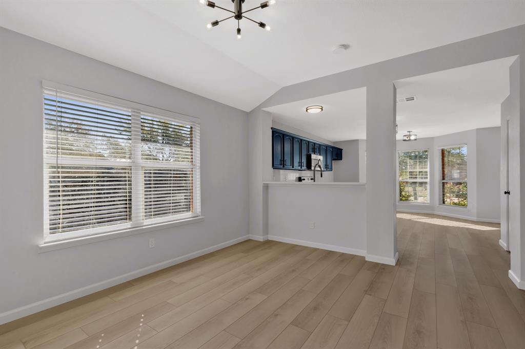 4172 Freedom Lane Frisco, TX 75033 - Photo 10 of 28 a view of an empty room with a window and wooden floor