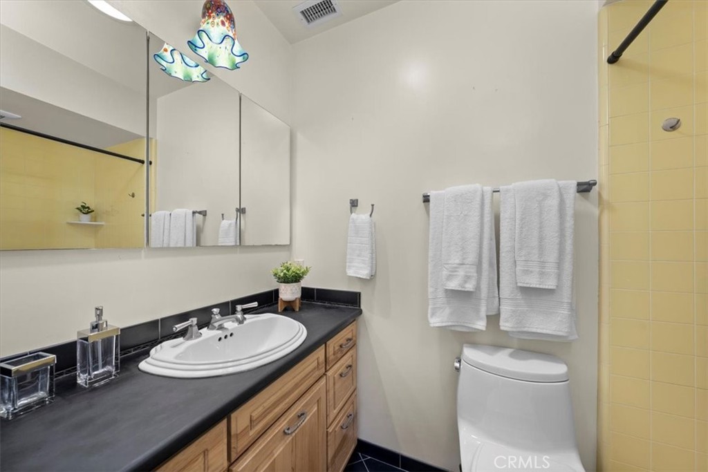 243 Park Avenue Long Beach, CA 90803 - Photo 18 of 52 a bathroom with a double vanity sink mirror and toilet
