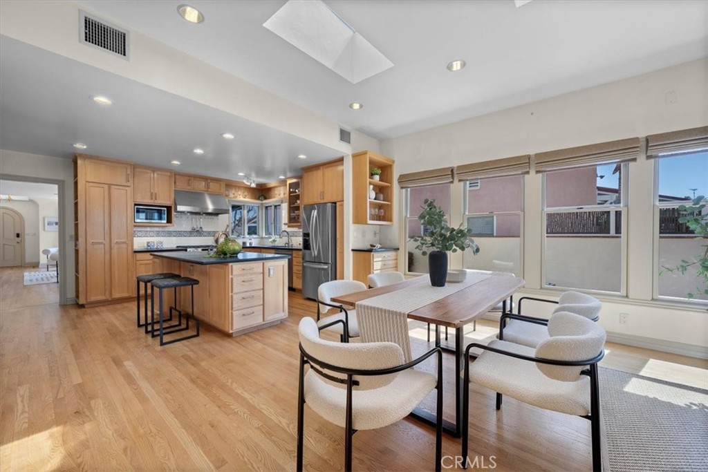 243 Park Avenue Long Beach, CA 90803 - Photo 9 of 52 a kitchen with a table chairs refrigerator and cabinets