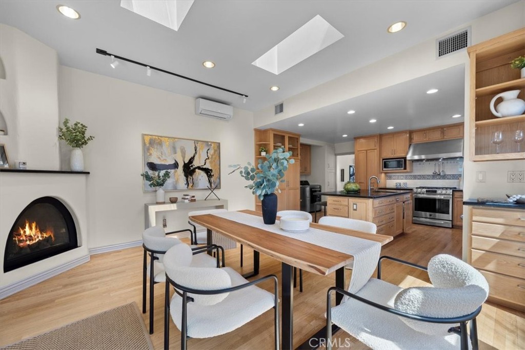 243 Park Avenue Long Beach, CA 90803 - Photo 10 of 52 a dining room with furniture and a fireplace