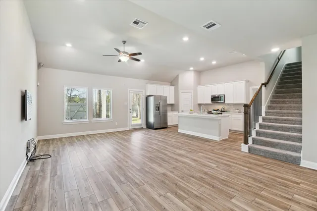 a view of kitchen and hall with wooden floor
