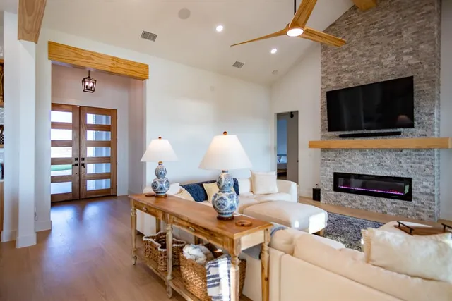 a living room with fireplace furniture and a flat screen tv