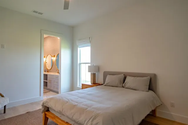 a bedroom with a bed and window