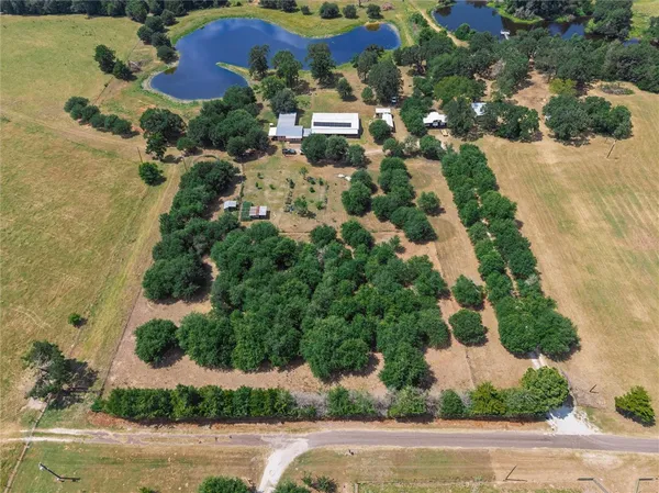 an aerial view of a house with a yard and garden