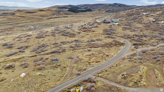349 West Mountain View Road, Unit 349 Fairview, UT 84629 - Photo 4 of 26 Expansive property featuring a winding paved road, undulating terrain, and distant hills