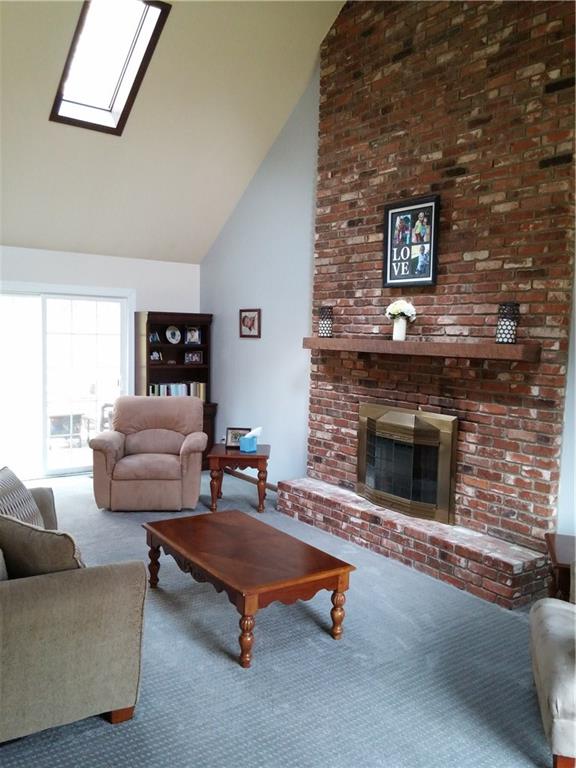 390 Richard Road Wexford, PA 15090 - Photo 9 of 21 Family room with floor-to-ceiling brick fireplace and cathedral ceiling with skylights and new wall-wall carpeting