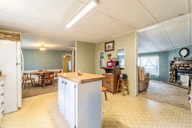 a living room with furniture and a kitchen view