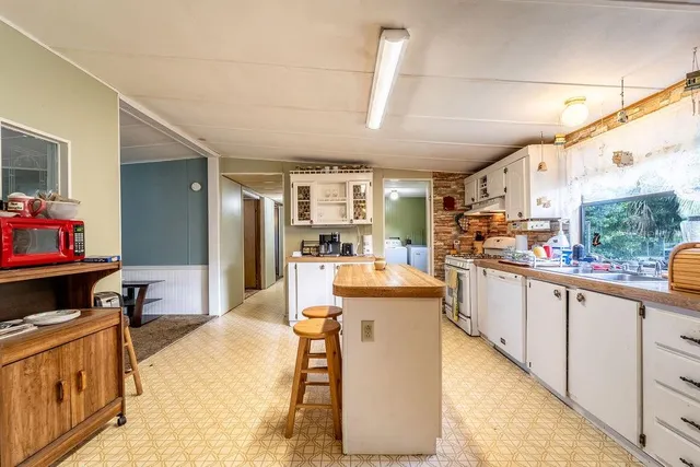 a kitchen with a sink cabinets and window