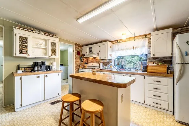 a kitchen with appliances cabinets and a table