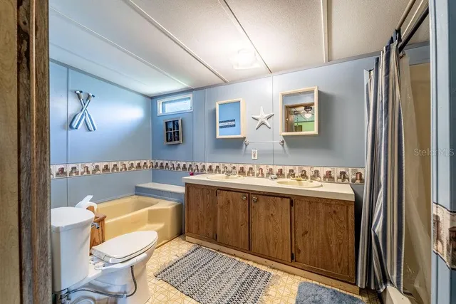 a view of a bathroom with a tub and shower