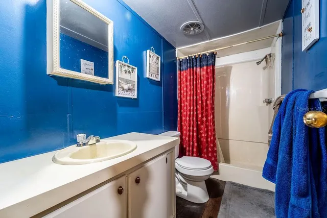 a bedroom with a bed dresser and a window