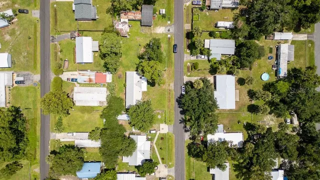 an aerial view of residential houses with outdoor and green space