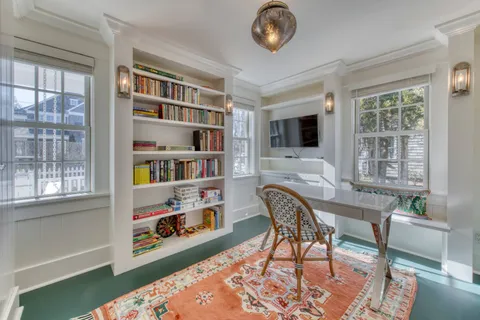 a workspace with furniture bookshelf and a window