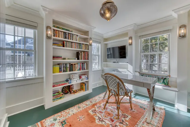 a workspace with furniture bookshelf and a window