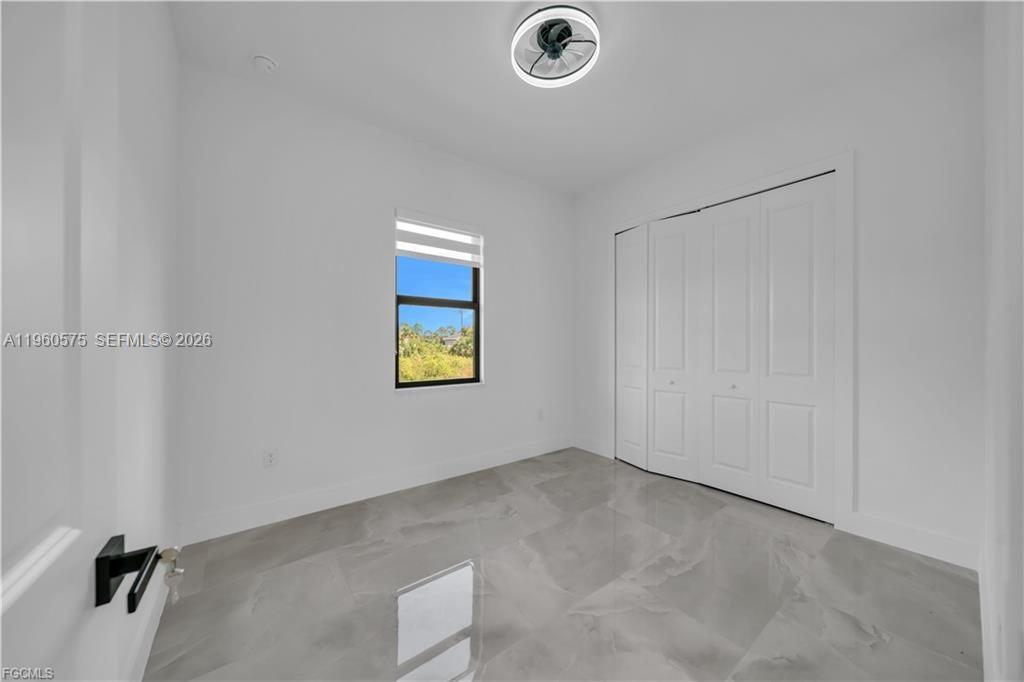 711 Roma Avenue Lehigh Acres, FL 33974 - Photo 22 of 38 a view of a room that has a window in it