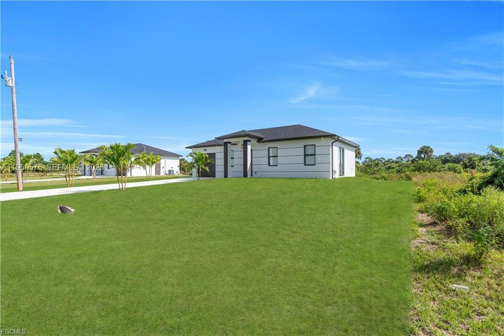 711 Roma Avenue Lehigh Acres, FL 33974 - Photo 27 of 38 a house view with garden space