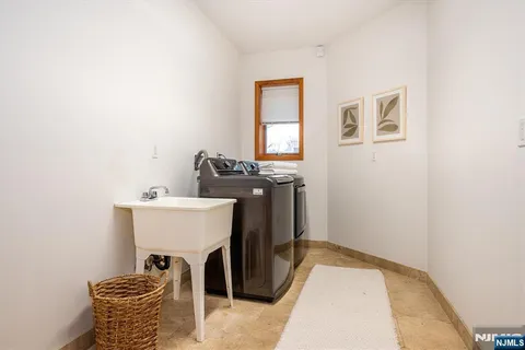 a living room with furniture large window and flat screen tv