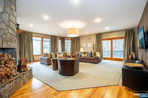 a living room with furniture a fireplace and a large window